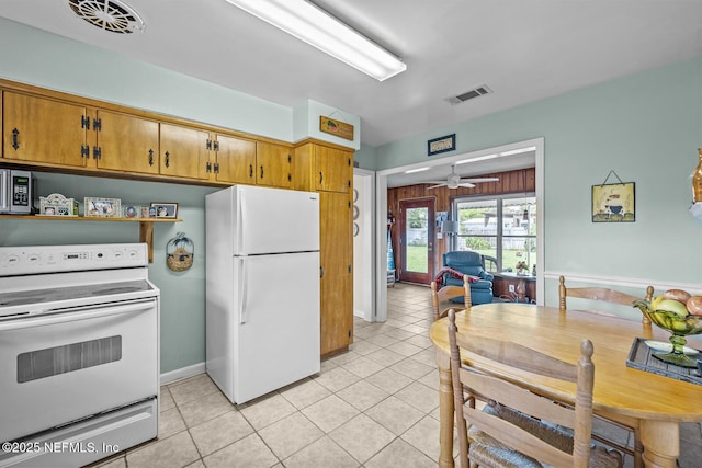 kitchen with white appliances, ceiling fan, light tile patterned floors, and brown cabinets