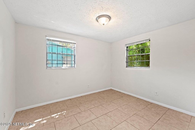 4504 Lincrest Dr S, Jacksonville, FL 32208 - spare room with a textured ceiling, baseboards, and tile patterned floors