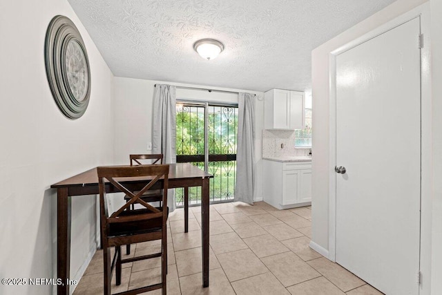 4504 Lincrest Dr S, Jacksonville, FL 32208 - dining room featuring a textured ceiling and light tile patterned flooring