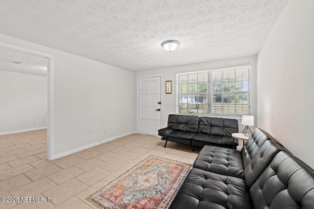 4504 Lincrest Dr S, Jacksonville, FL 32208 - living area featuring a textured ceiling, light tile patterned flooring, and baseboards