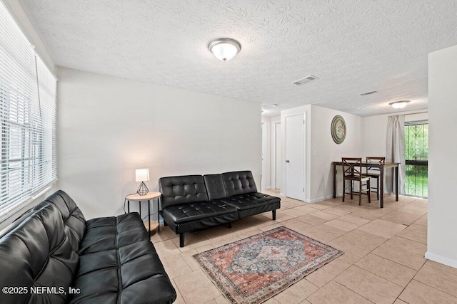 4504 Lincrest Dr S, Jacksonville, FL 32208 - tiled living area with a textured ceiling and baseboards