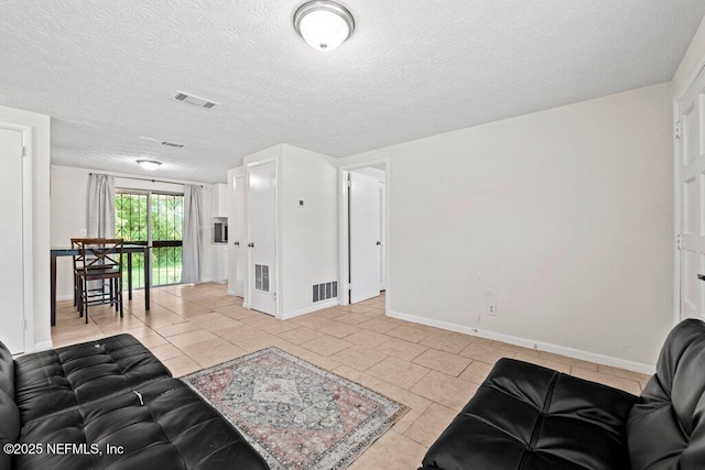 4504 Lincrest Dr S, Jacksonville, FL 32208 - living room featuring baseboards, light tile patterned floors, and a textured ceiling