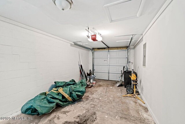 4504 Lincrest Dr S, Jacksonville, FL 32208 - garage featuring a garage door opener, electric panel, and concrete block wall