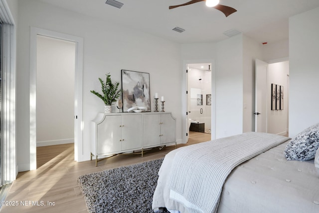 bedroom featuring light wood-style flooring, baseboards, ensuite bath, and ceiling fan