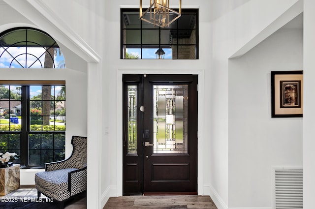 108 Spanish Moss Ln, Ponte Vedra Beach, FL 32082 - foyer featuring a chandelier, a towering ceiling, baseboards, and wood finished floors