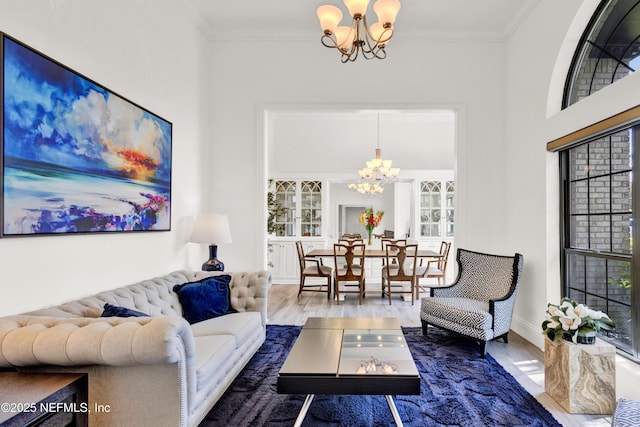 108 Spanish Moss Ln, Ponte Vedra Beach, FL 32082 - living room featuring a chandelier, wood finished floors, crown molding, and baseboards