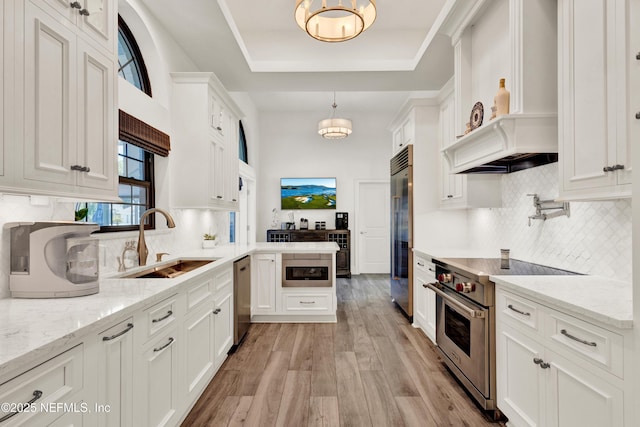 108 Spanish Moss Ln, Ponte Vedra Beach, FL 32082 - kitchen with high quality appliances, a sink, light wood-style floors, and white cabinetry