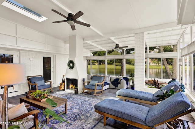 108 Spanish Moss Ln, Ponte Vedra Beach, FL 32082 - sunroom with a ceiling fan, an outdoor living space with a fireplace, a skylight, and beam ceiling