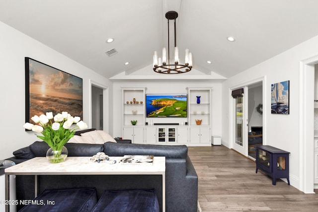 108 Spanish Moss Ln, Ponte Vedra Beach, FL 32082 - living room featuring lofted ceiling, a chandelier, wood finished floors, built in shelves, and recessed lighting