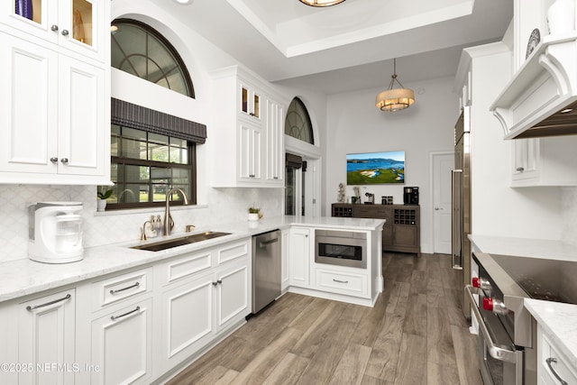 108 Spanish Moss Ln, Ponte Vedra Beach, FL 32082 - kitchen with appliances with stainless steel finishes, a sink, ventilation hood, and white cabinetry