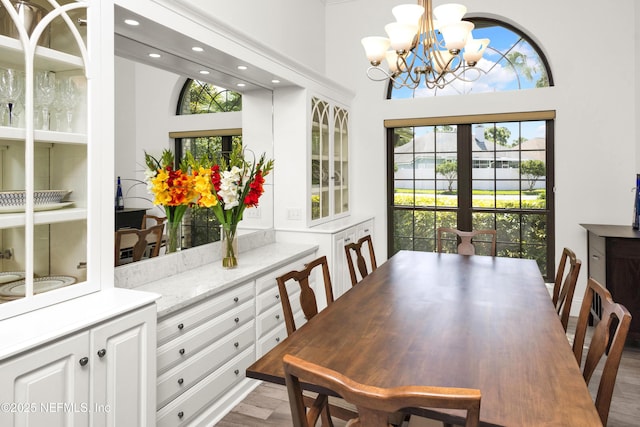108 Spanish Moss Ln, Ponte Vedra Beach, FL 32082 - dining room with a chandelier, a towering ceiling, wood finished floors, and recessed lighting