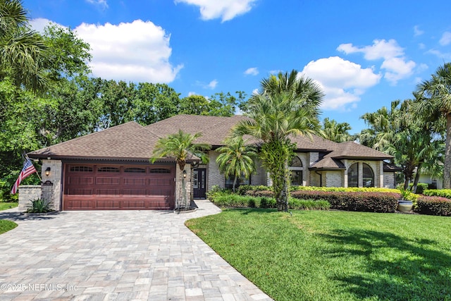 108 Spanish Moss Ln, Ponte Vedra Beach, FL 32082 - view of front of home with a garage, decorative driveway, a front lawn, and brick siding