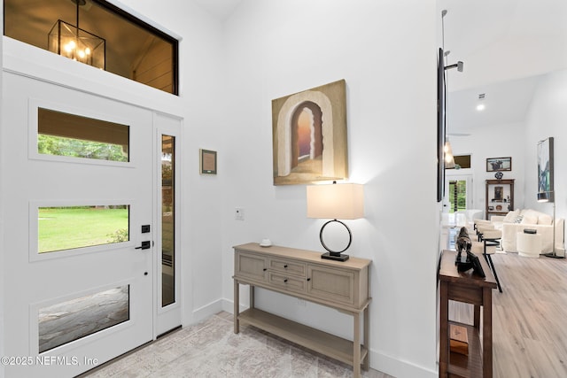 33 Loggerhead Ln, Ponte Vedra Beach, FL 32082 - entryway featuring a towering ceiling, plenty of natural light, light wood finished floors, and baseboards