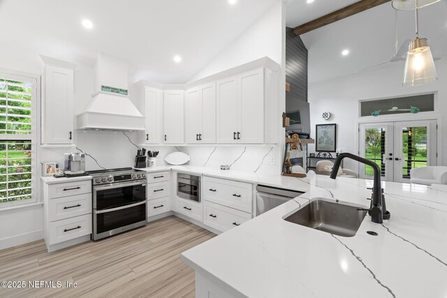 33 Loggerhead Ln, Ponte Vedra Beach, FL 32082 - kitchen with a sink, stainless steel appliances, french doors, premium range hood, and light stone countertops