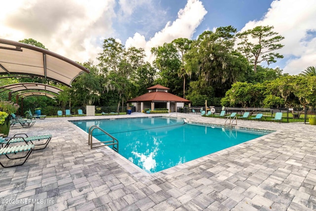 33 Loggerhead Ln, Ponte Vedra Beach, FL 32082 - community pool featuring a gazebo, a patio area, fence, and view of scattered trees