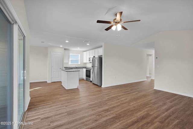 37135 Whippoorwill Ct, Hilliard, FL 32046 - unfurnished living room featuring ceiling fan, wood finished floors, baseboards, recessed lighting, and vaulted ceiling