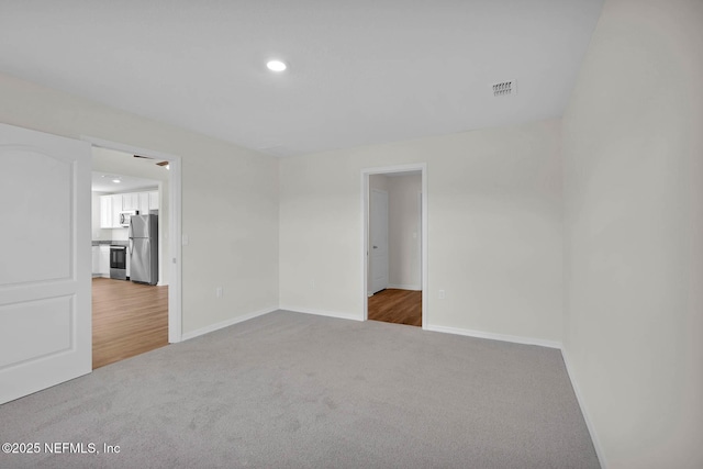 37135 Whippoorwill Ct, Hilliard, FL 32046 - unfurnished bedroom with freestanding refrigerator, carpet flooring, baseboards, and recessed lighting