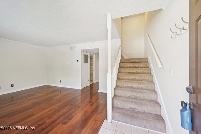4813 Cherwell Ln Unit B-4-C, Jacksonville, FL 32217 - staircase with crown molding, wood finished floors, baseboards, and a textured ceiling