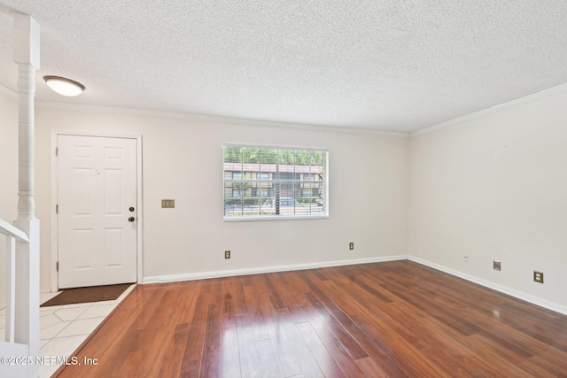 4813 Cherwell Ln Unit B-4-C, Jacksonville, FL 32217 - foyer featuring hardwood / wood-style floors, ornamental molding, a textured ceiling, and baseboards