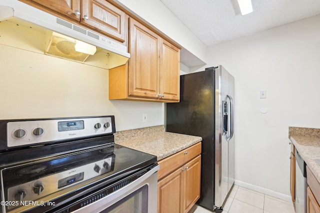4813 Cherwell Ln Unit B-4-C, Jacksonville, FL 32217 - kitchen featuring appliances with stainless steel finishes, under cabinet range hood, light tile patterned flooring, light countertops, and baseboards