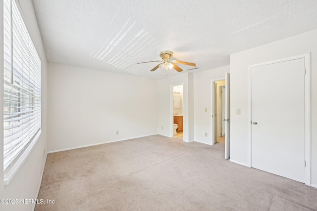 4813 Cherwell Ln Unit B-4-C, Jacksonville, FL 32217 - unfurnished bedroom with light colored carpet, a textured ceiling, ensuite bathroom, ceiling fan, and baseboards