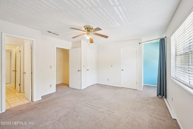 4813 Cherwell Ln Unit B-4-C, Jacksonville, FL 32217 - unfurnished bedroom featuring carpet, a textured ceiling, ceiling fan, and baseboards