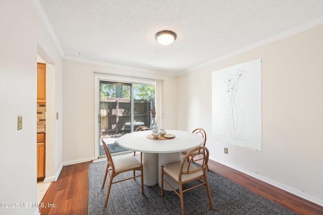 4813 Cherwell Ln Unit B-4-C, Jacksonville, FL 32217 - dining space featuring crown molding, wood finished floors, a textured ceiling, and baseboards