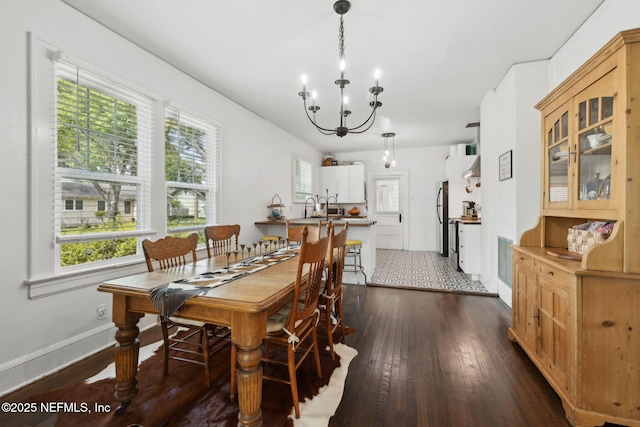 1267 Murray Dr, Jacksonville, FL 32205 - dining room with dark wood-type flooring, a chandelier, and baseboards