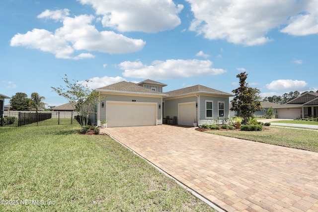 view of front facade with an attached garage, decorative driveway, and roof with shingles