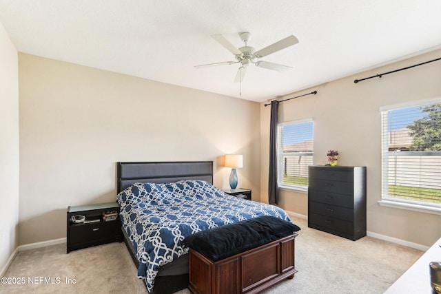 bedroom with light carpet, baseboards, and a ceiling fan