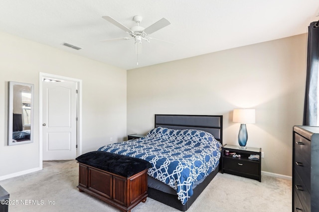 bedroom featuring baseboards, light colored carpet, and a ceiling fan