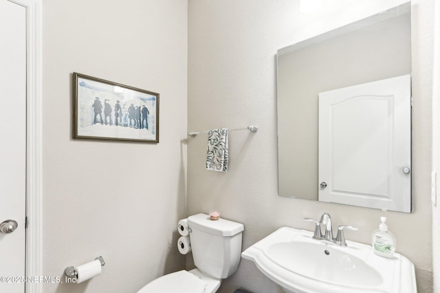 half bath with a sink and toilet