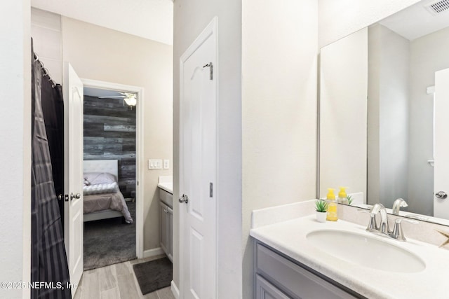 bathroom with vanity and ensuite bathroom