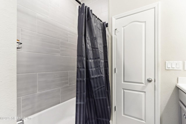 full bath featuring vanity and shower / bath combination with curtain