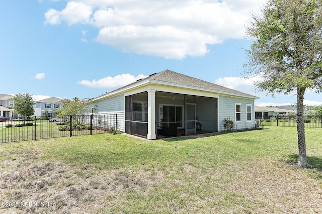 back of property with a sunroom