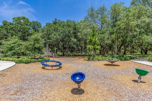 view of play area featuring view of wooded area