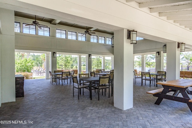view of patio / terrace with ceiling fan, outdoor dining area, and fence