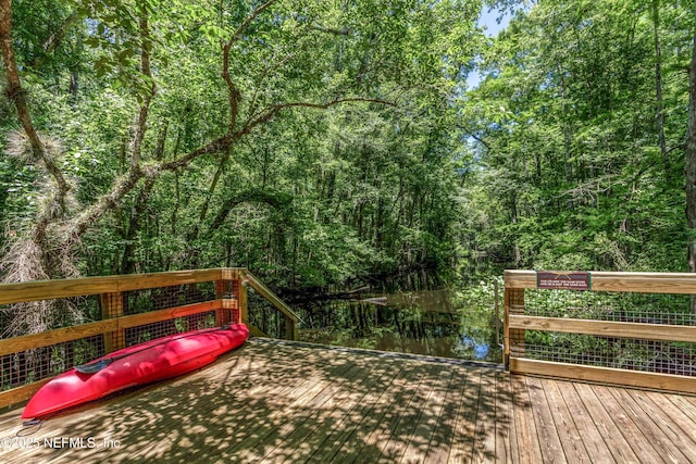 wooden terrace with a wooded view