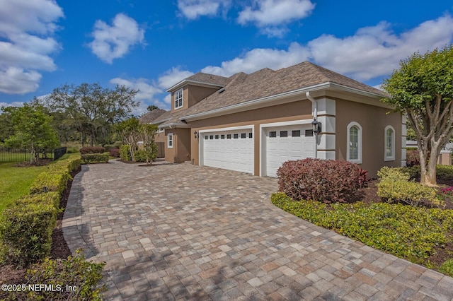2624 Oakgrove Ave, Saint Augustine, FL 32092 - view of front of home with decorative driveway, an attached garage, and stucco siding
