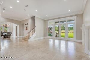 2624 Oakgrove Ave, Saint Augustine, FL 32092 - living room featuring arched walkways, recessed lighting, stairway, baseboards, and ornamental molding