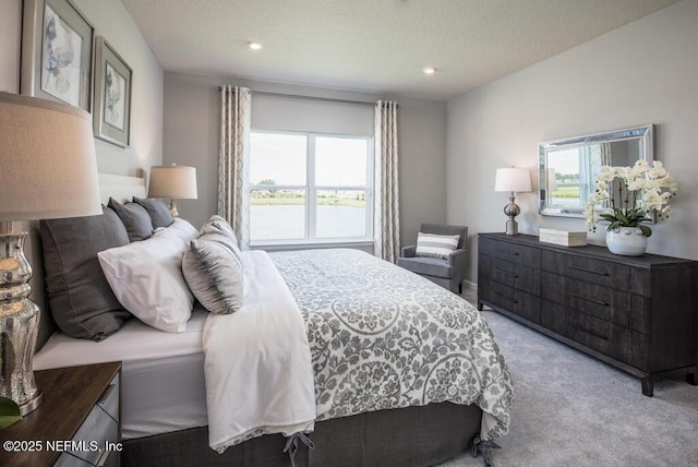 carpeted bedroom featuring multiple windows and recessed lighting