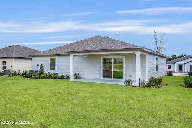 37143 Whippoorwill Ct, Hilliard, FL 32046 - back of property featuring central air condition unit, a yard, roof with shingles, and a patio