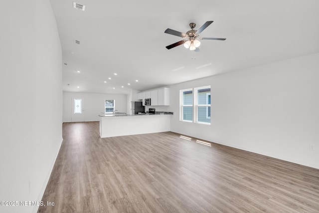 37143 Whippoorwill Ct, Hilliard, FL 32046 - unfurnished living room featuring ceiling fan, light wood-style floors, and recessed lighting