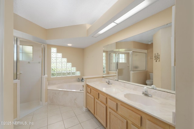 1530 Blue Heron Ct, Fleming Island, FL 32003 - bathroom with a bath, a shower stall, double vanity, toilet, and tile patterned floors