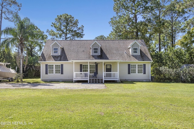 cape cod home with covered porch, a front yard, and roof with shingles