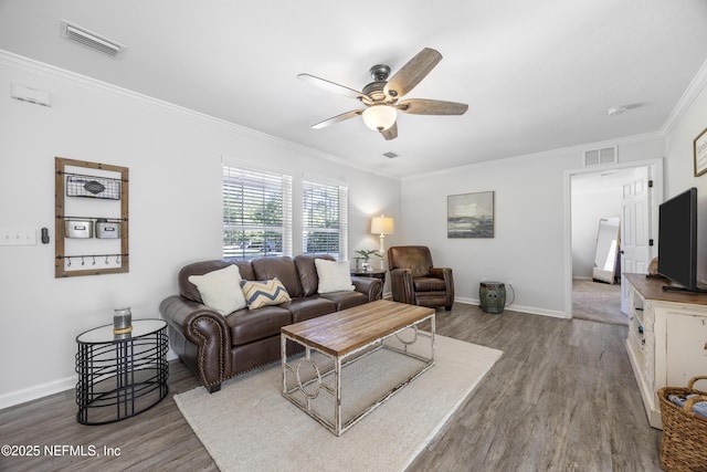 living area with ceiling fan, wood finished floors, crown molding, and baseboards