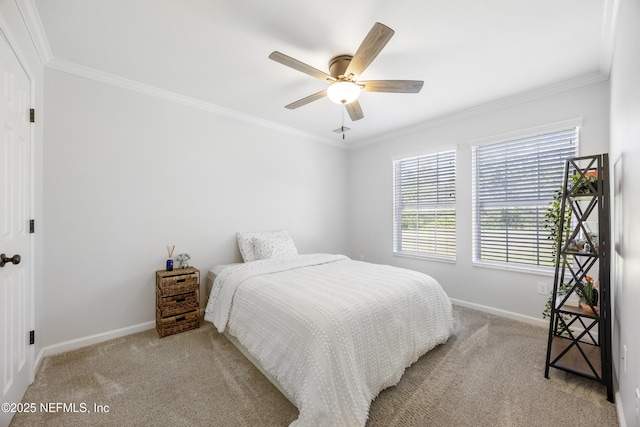 carpeted bedroom with crown molding, multiple windows, baseboards, and a ceiling fan