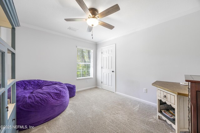 sitting room with crown molding, ceiling fan, carpet flooring, and baseboards
