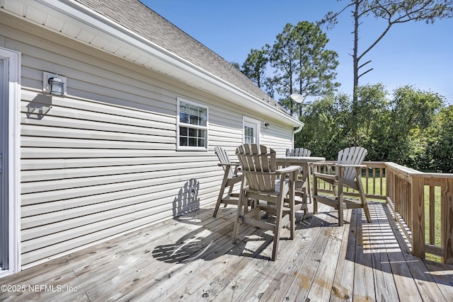wooden terrace with outdoor dining area