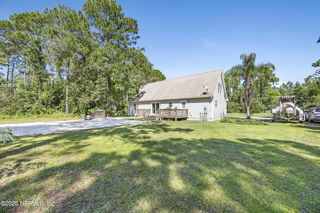 view of front of property with a deck and a front lawn